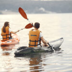 Women paddling on a lake in a kayak